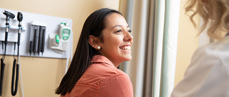 woman smiling with her doctor at Saint Vincent Hospital.